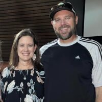 Kristin and Rodney Huffty are standing next to each other and smiling.