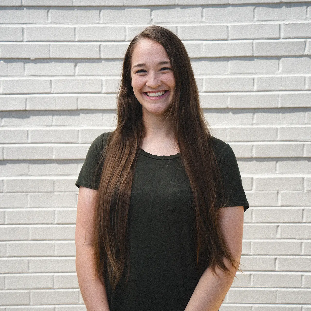 Allison Brown is smiling and wearing a black shirt.