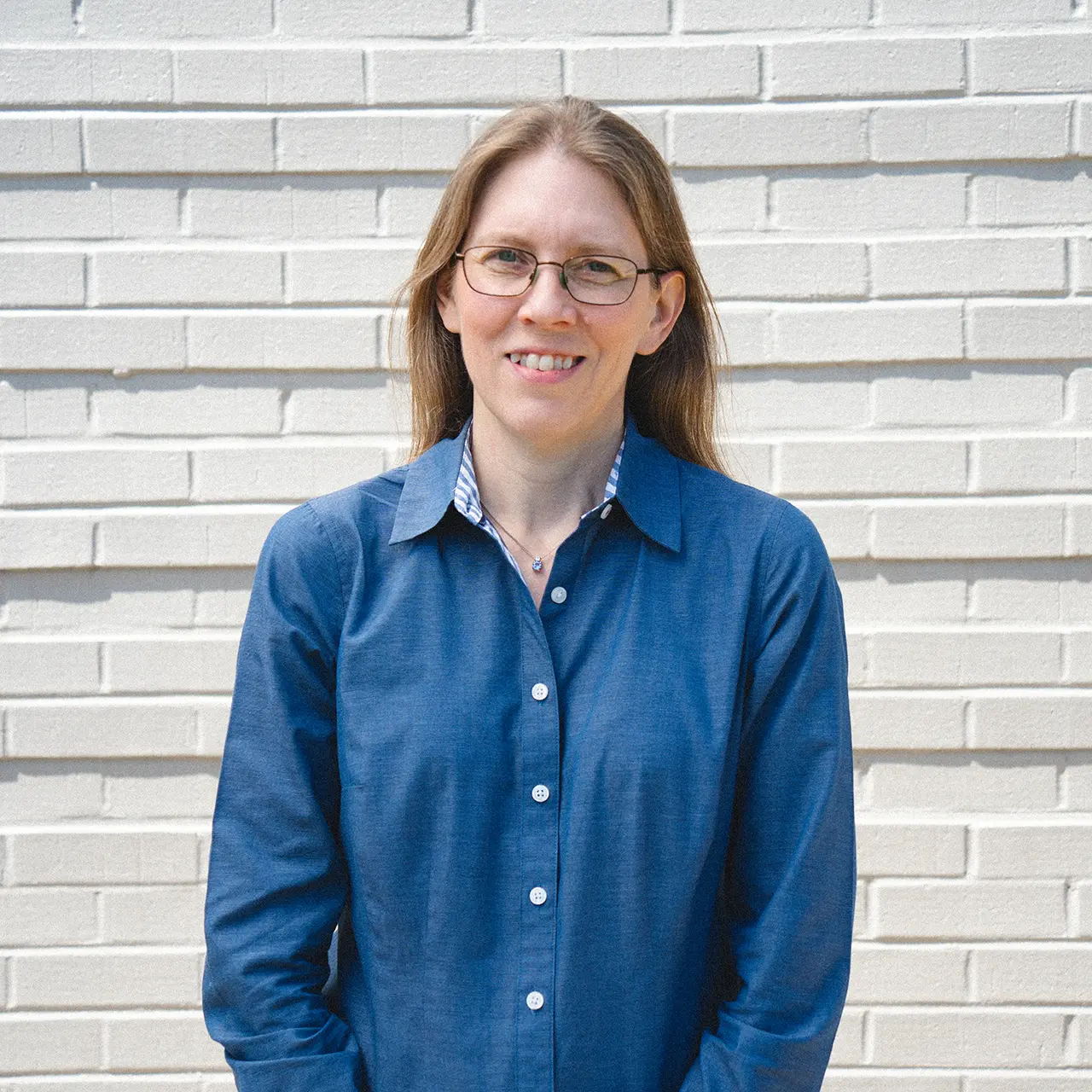 Christy Lapp is smiling and wearing a blue shirt.
