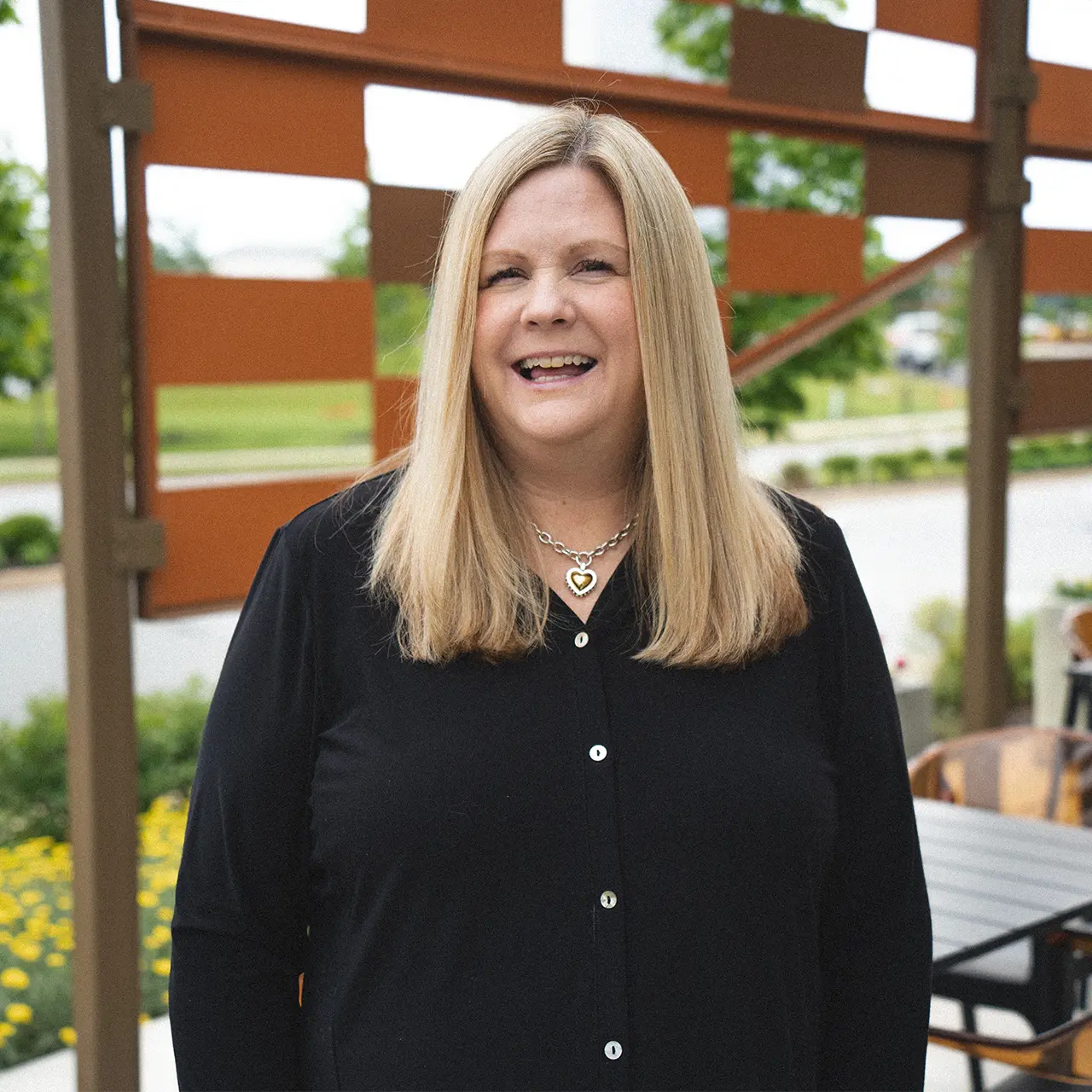 Kristi Pullig is smiling and wearing a black shirt.
