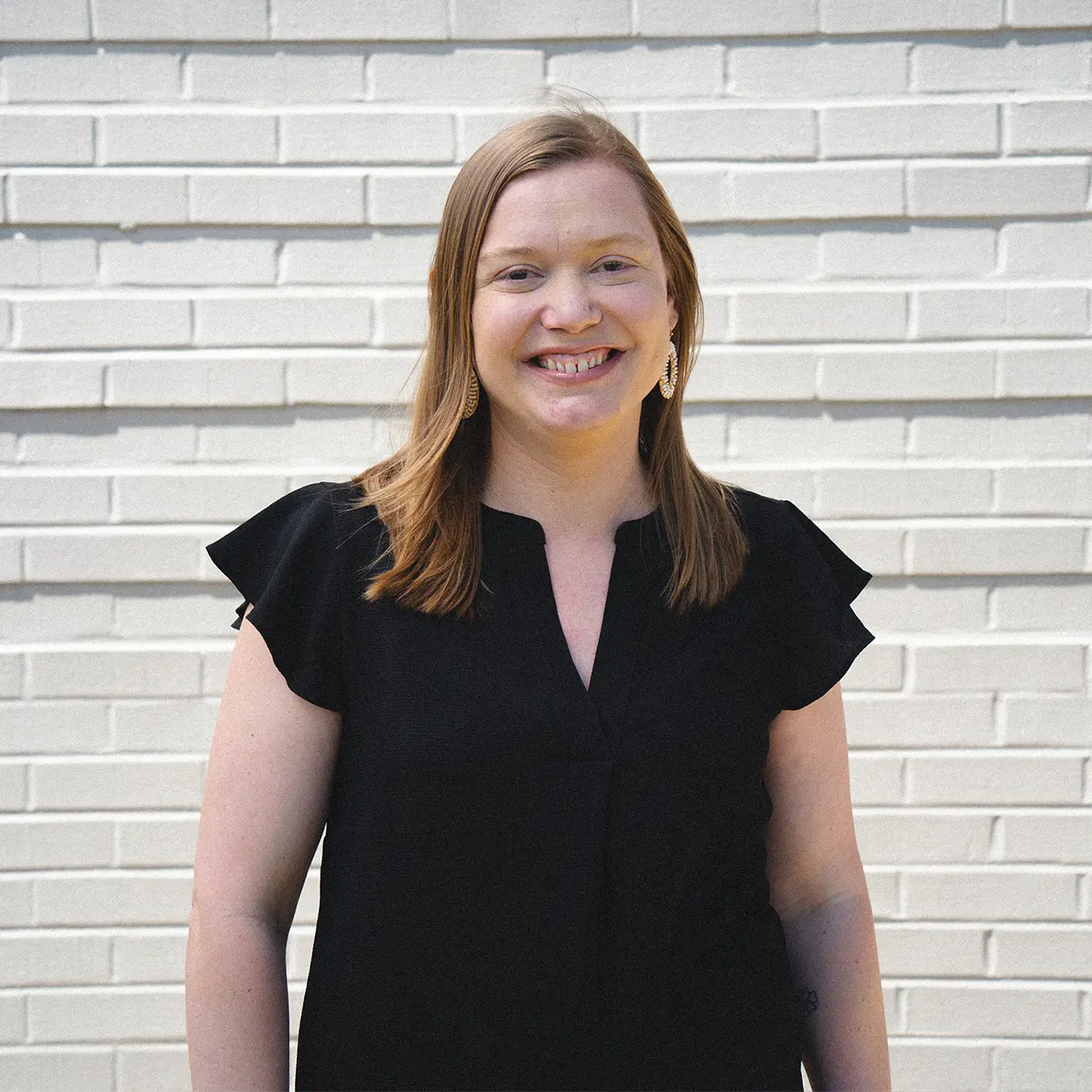 Melissa Stein is smiling and wearing a black shirt.