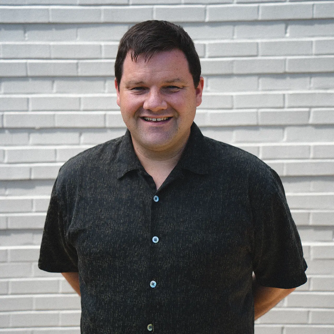 Seth Stein is smiling and wearing a black shirt.