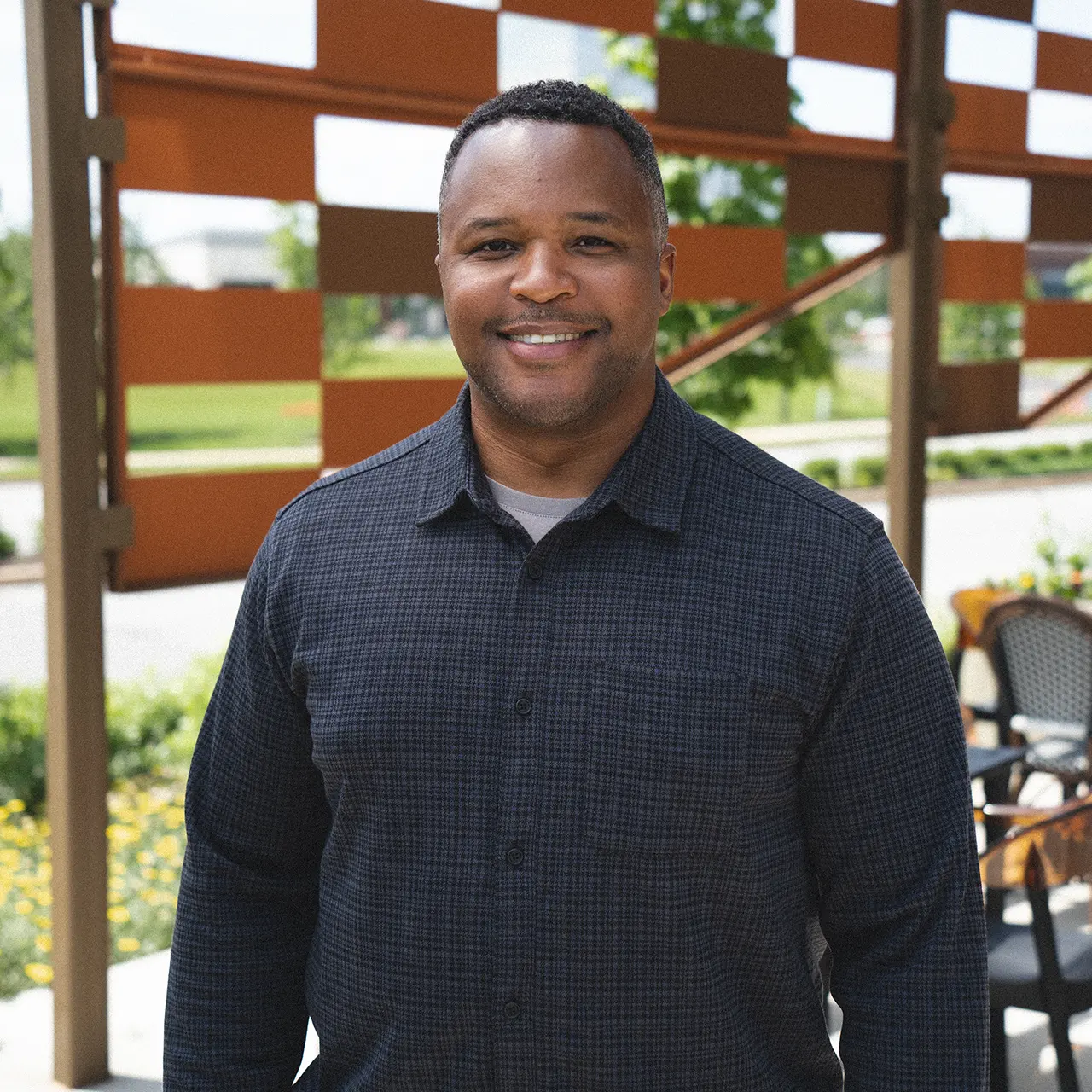 Todd Johnson is wearing a black shirt and smiling.